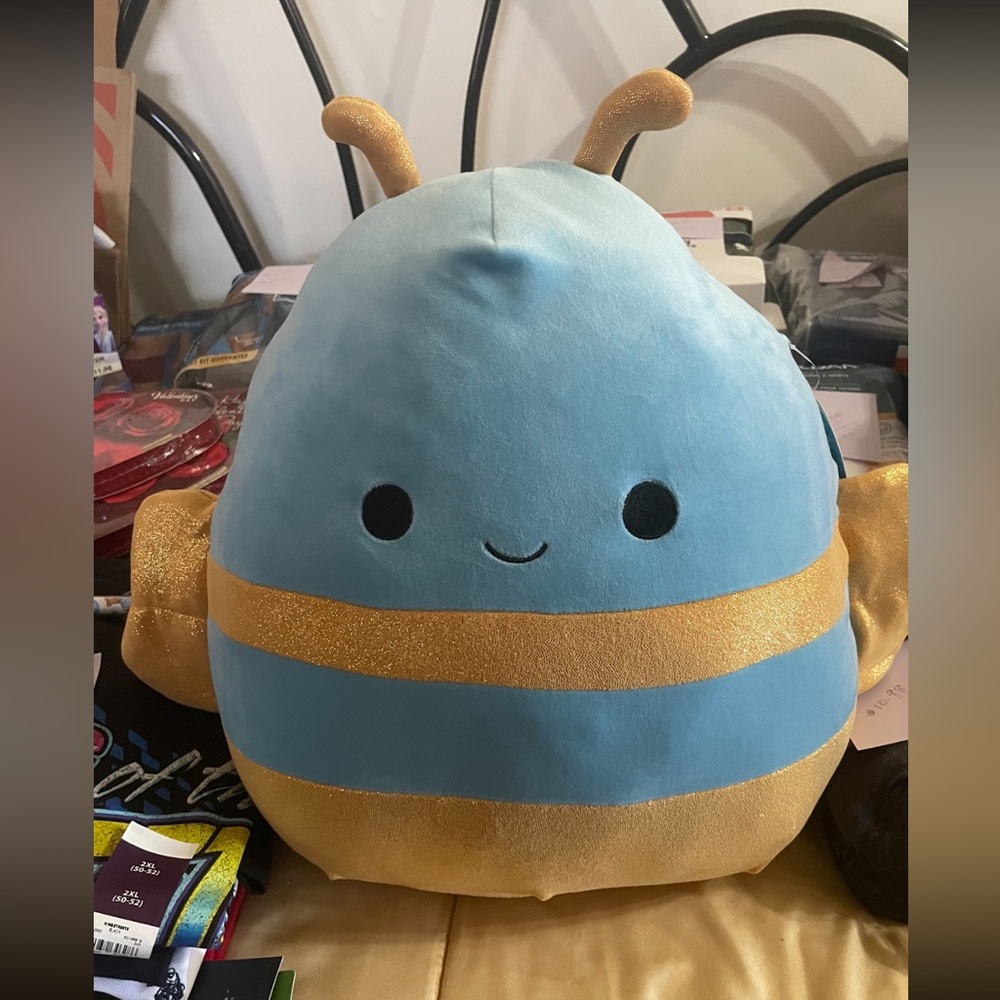 Squishmallows Queen Bee she is Blue and Gold.